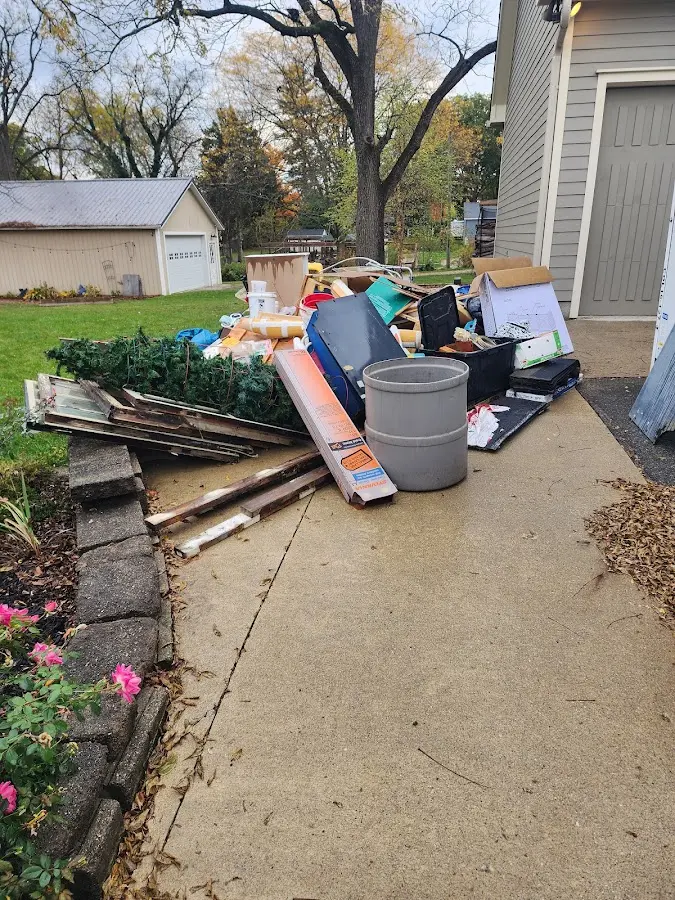 Dumpster being loaded with debris for 12 Yard Dumpster Rental in Jacksonville